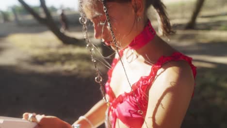woman in festival attire with decorative chains outdoors