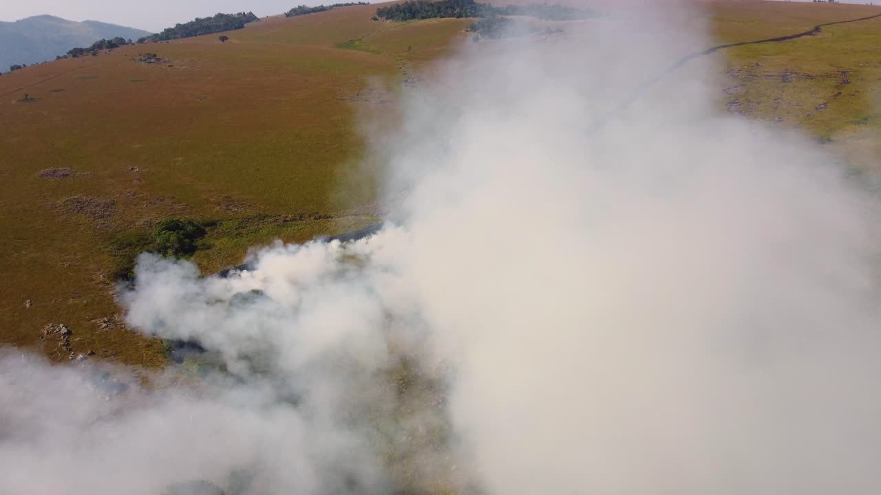 Drone view, patch mosaic burn in Drakensberg Mountains and Blyde River Canyon Nature Reserve. Controlled fire creates diverse landscape patterns to promote biodiversity in South African grasslands.