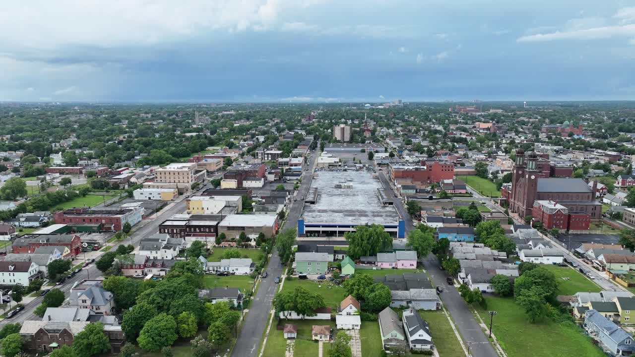 An aerial view of the green city of Buffalo, New York with storm clouds in the distance