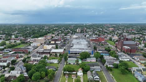 An-aerial-view-of-the-green-city-of-Buffalo,-New-York-with-storm-clouds-in-the-distance