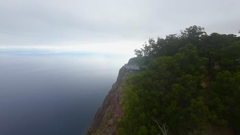 drone view of cabo girao and the coastal cliffs of madeira, portugal. popular tourist destination with amazing high views of the shoreline and sea from lookout point.
