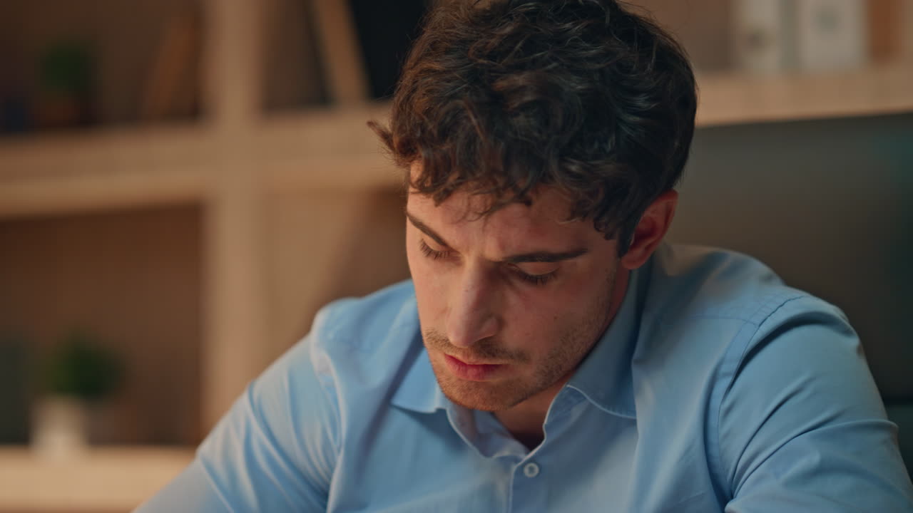 Overworked freelancer talking online meeting late evening in home office closeup