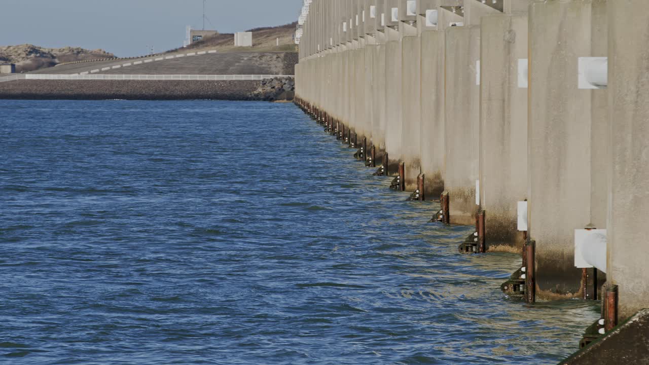 Strong waves crashing against the Oosterschelde storm surge barrier in Zeeland, Netherlands, super slow motion