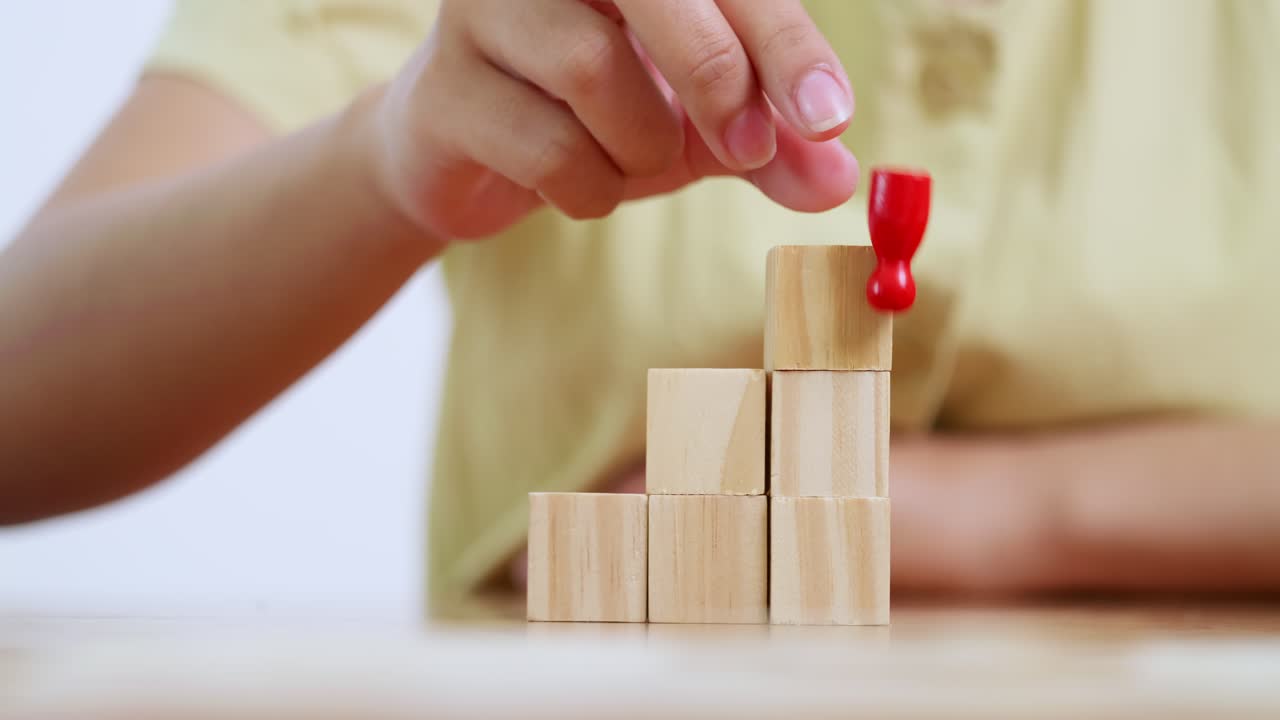 A child carefully stacks blocks enhancing learning and motor skills in a playful home setting