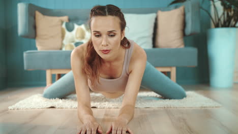 Closeup-expectant-mother-practicing-yoga.-Smiling-pregnant-woman-stretching-legs