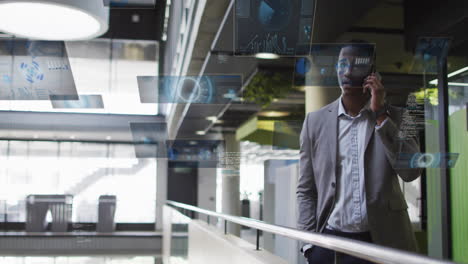 businessman talking on phone with digital data animations floating around him