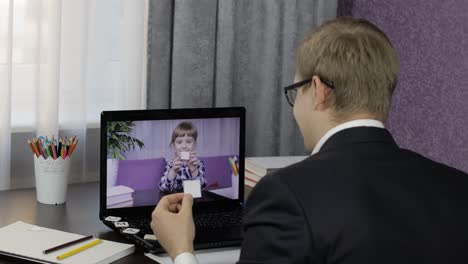 man teacher makes video call on laptop with children pupil. distance education