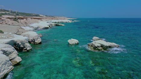 Flying-along-Mediterranean-coastline-past-turning-power-generating-wind-turbines