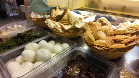 assorted asian food ingredients and street food items on display