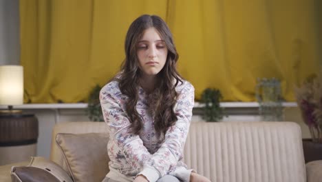 Portrait-of-sad-young-woman-at-night-at-home.