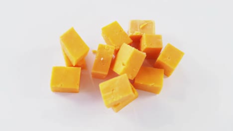 Yellow-cheese-cubes-on-white-background