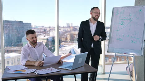 business meeting in office room. male entrepreneurs speaking about new business plans in office. successful employees working indoors.