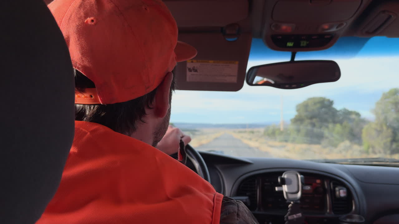 Back shot of hunter driving to Mule Deer Hunting location in Colorado, USA