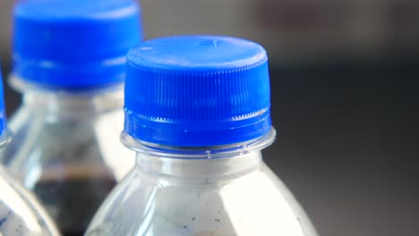 close-up of soda bottles with blue lids