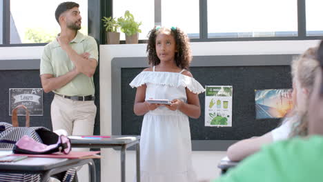 biracial girl presents in school classroom