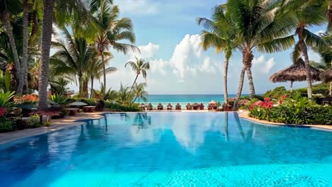 a large swimming pool surrounded by palm trees and umbrellas