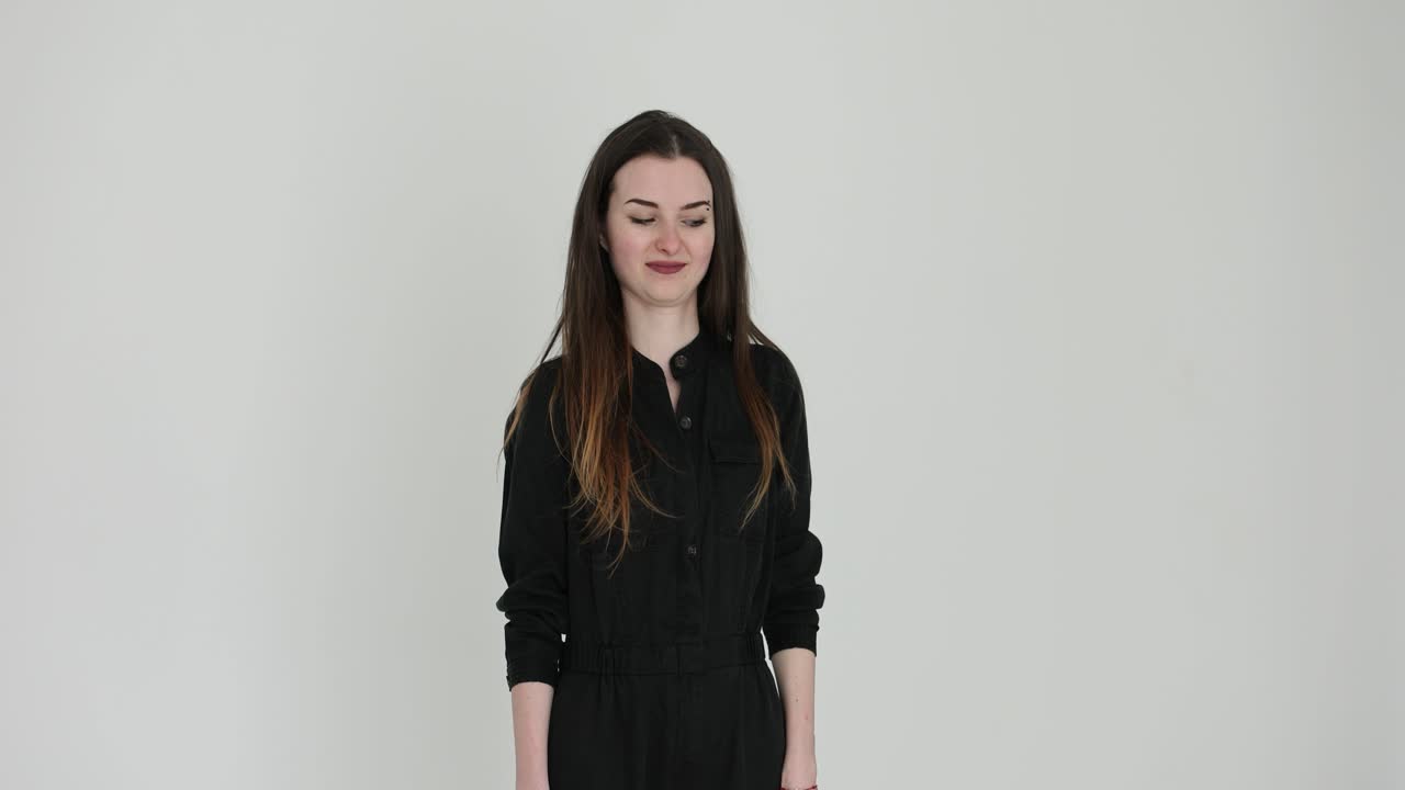 Young Woman Posing and Expressing Emotions in a White Studio