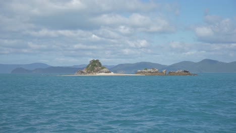 Rugged-Island-In-The-Midst-Of-Coral-Sea-Near-Hamilton-Island-In-Whitsundays,-Queensland-On-A-Sunny-Day