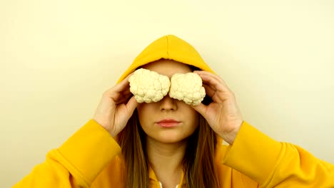 fancy caucasian model with fresh vegetables on eyes. stop motion looped.