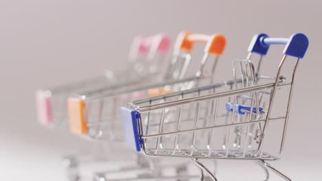 three empty shopping trollies on seamless white background