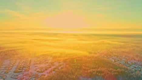 a bright sunrise morning in winter above a suburb in the forest - aerial flyover