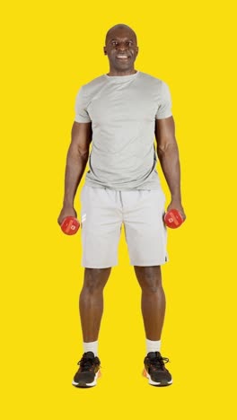 african man doing curl biceps exercise with dumbbells alternating arm