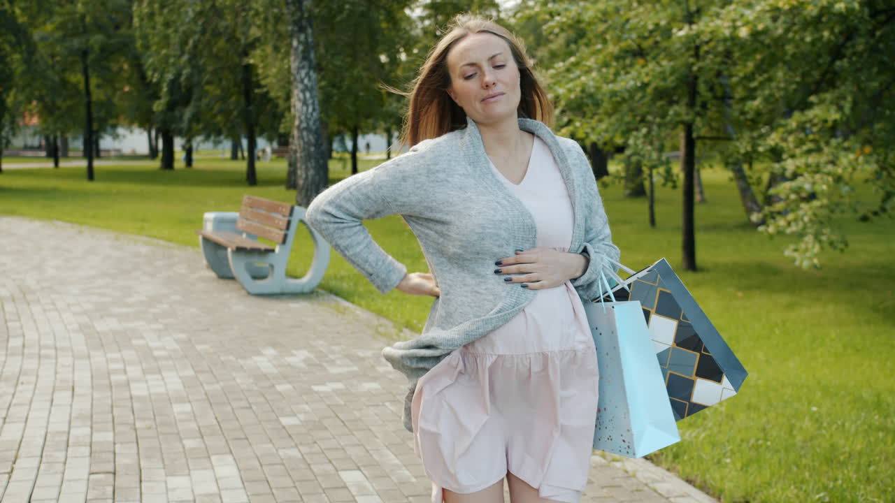 Pregnant Woman Shopping in the Park