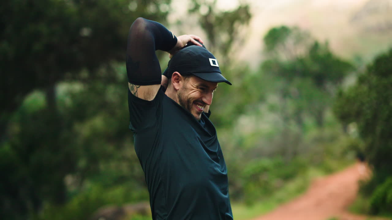 Man stretching on a trail in nature
