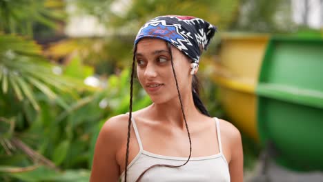 young woman with head wrap and braids outdoors