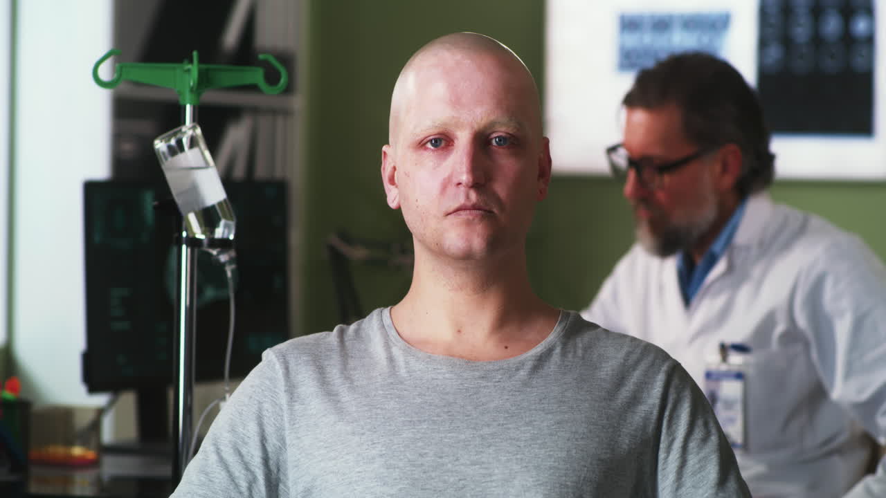 Bald Patient Undergoing Treatment with Doctor in Hospital Room