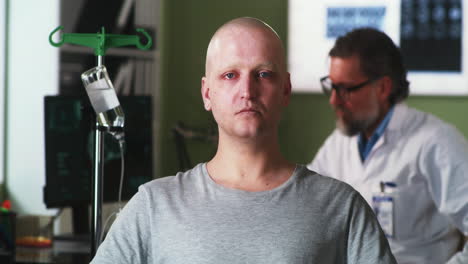 bald patient undergoing treatment with doctor in hospital room