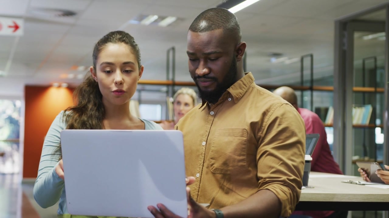 Colleagues pointing at laptop, auto subscribe overlay animating for social media, then collapsing