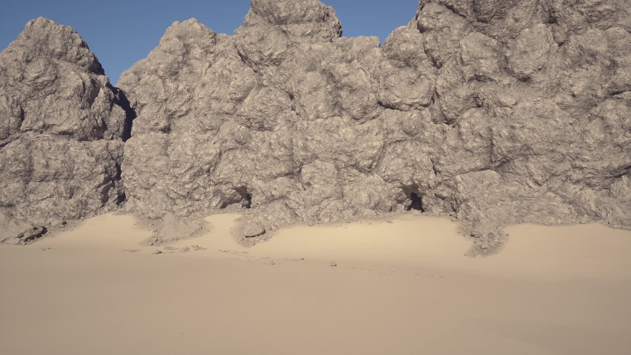 Expansive sandy landscape bordered by cliffs beneath clear sky