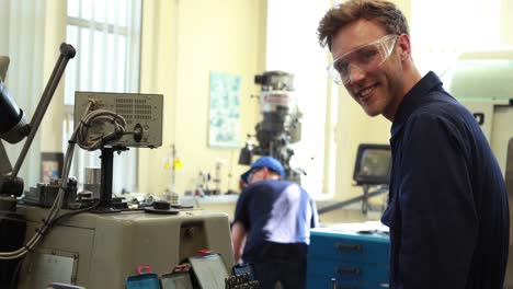 Young-mechanic-smiling-at-camera