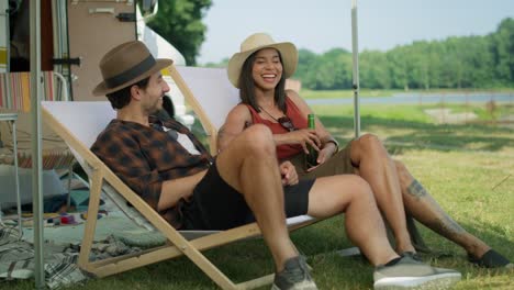 friends spending time on the camping side and drinking beer