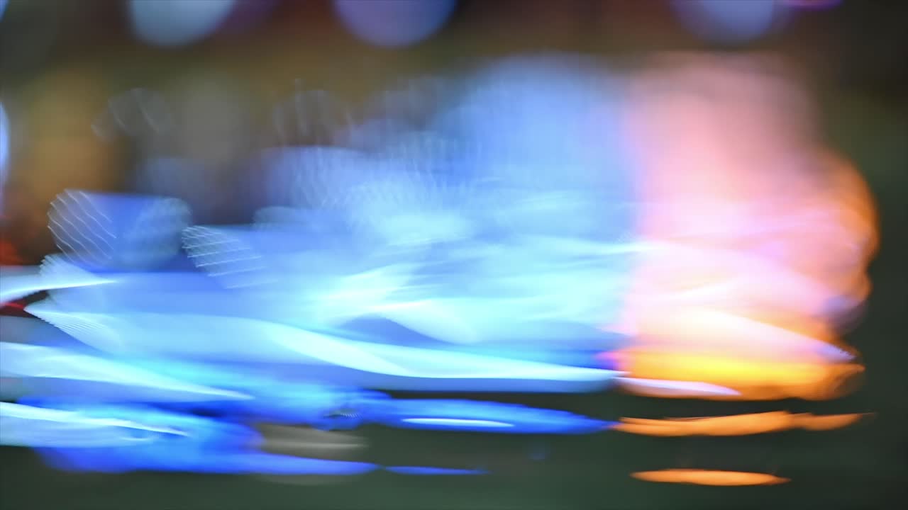 Blue and orange lights reflecting on water