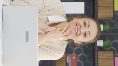 Vertical-video-of-Happy-and-peaceful-business-woman-talking-to-camera.