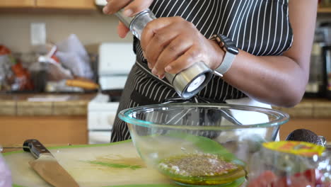 grinding salt in the homemade italian salad dressing for a chopped salad - antipasto salad series