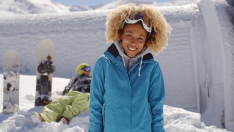 cute skier in front of friend in snow