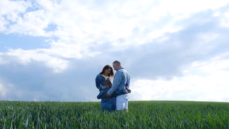 happy family are walking in the open green field happy family are walking in the open green field friendly family vacation together hiking in nature from a birds eye view people spend time carefree outdoors in the summer in a public park
