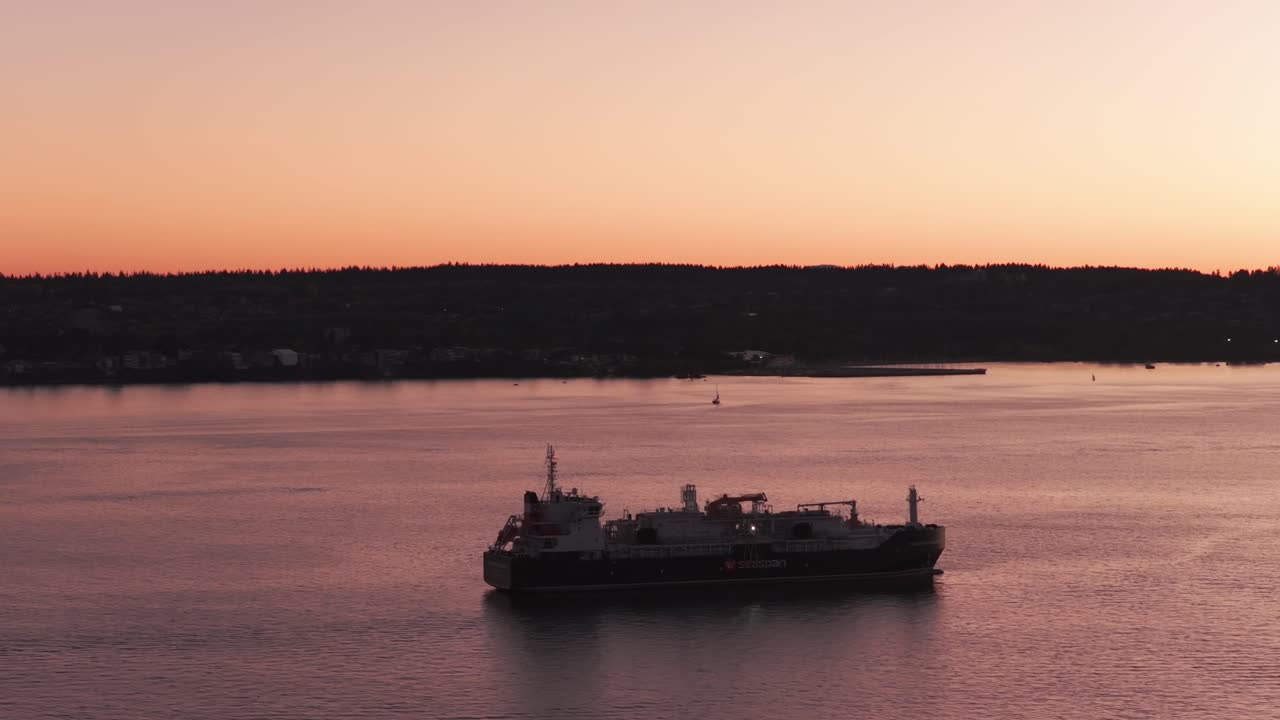 Telephoto panning aerial shot of a bunkering tanker at golden hour near Vancouver, British Columbia, Canada. 4K