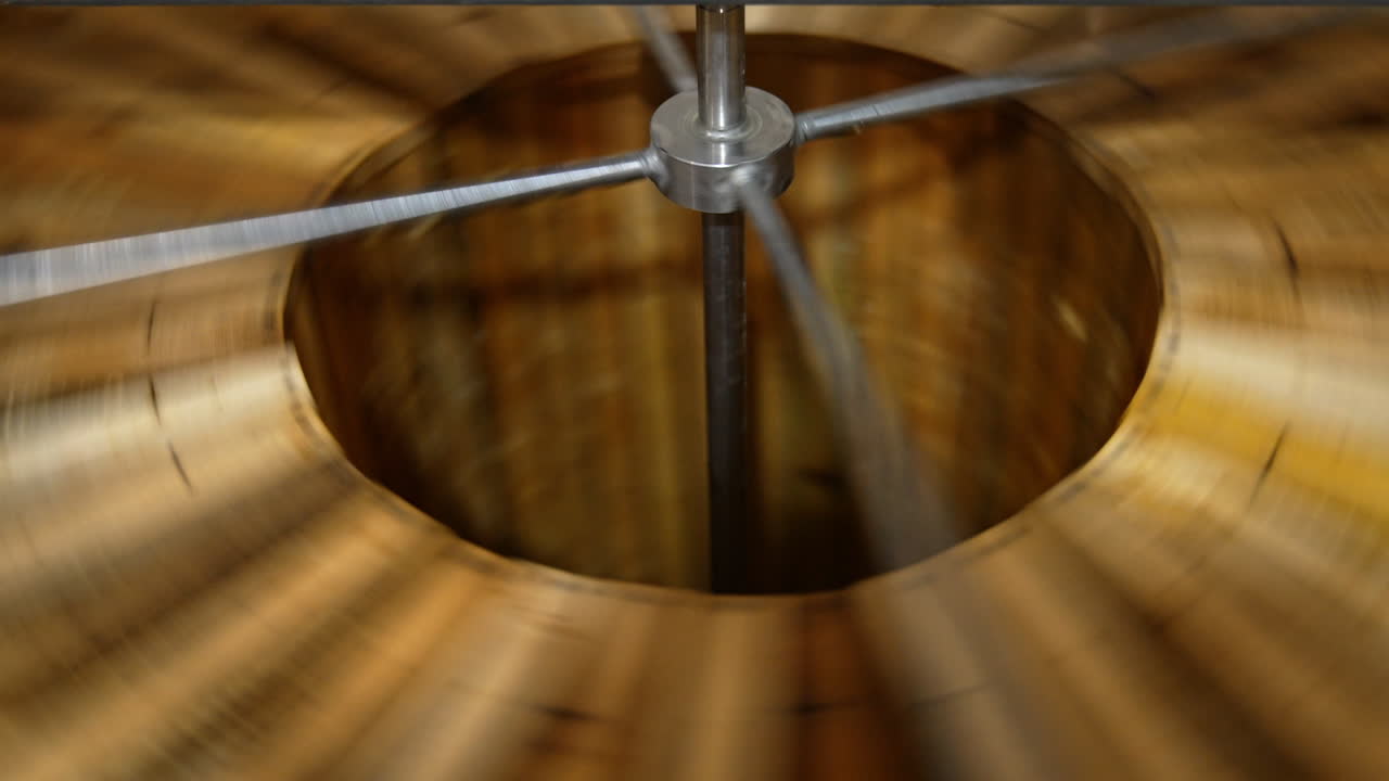 Centrifuge rotating quickly to extract honey from frames. Apiary machine for harvesting organic fresh honey.