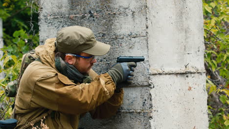 a man plays airsoft with a pistol in his hand