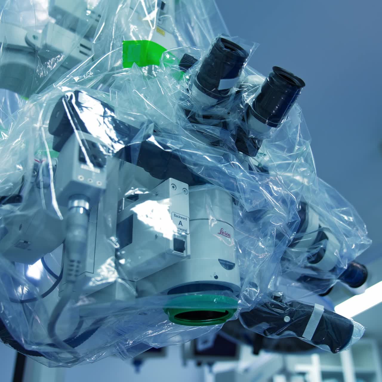 Equipment in surgery room coated with plastic. Moving around the advanced microscope for precise operations from low angle perspective