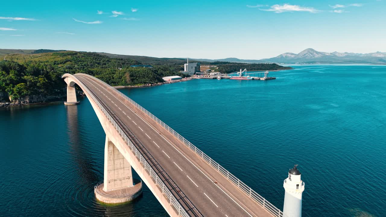 Bridge over the sea with mountains in the background