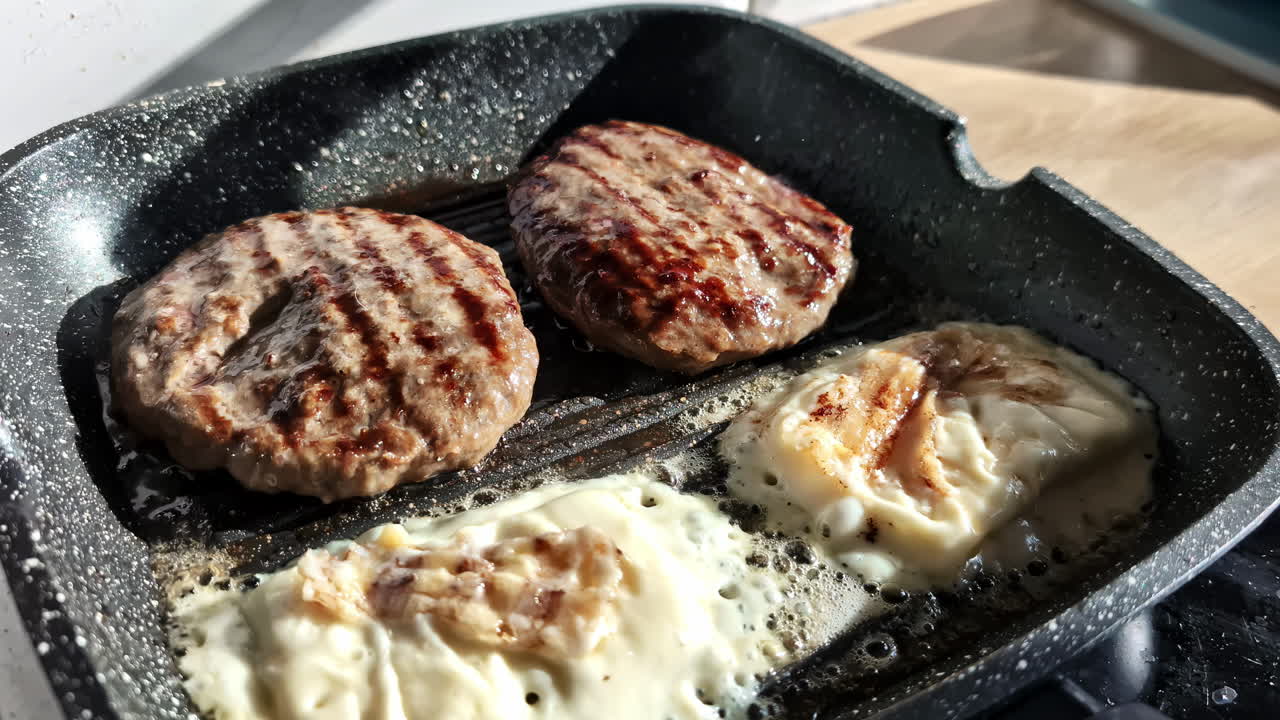 Close-up shot of sizzling burger patties and melting cheese on a BBQ grill pan, creating a mouth-watering scene.