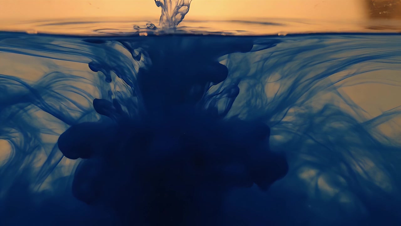 Blue Ink Dropping and Dissolving in Clear Water