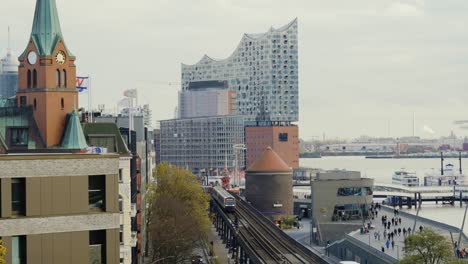 train driving towards in hamburg city with elbphilharmonie in background