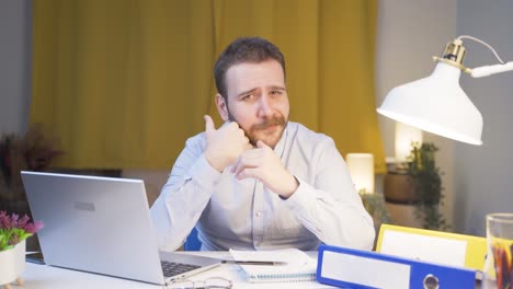 Home-office-worker-man-looks-at-camera-with-happy-and-smiling-face.