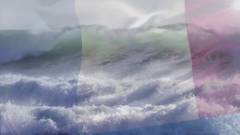 Digital-composition-of-waving-france-flag-against-aerial-view-of-waves-in-the-sea